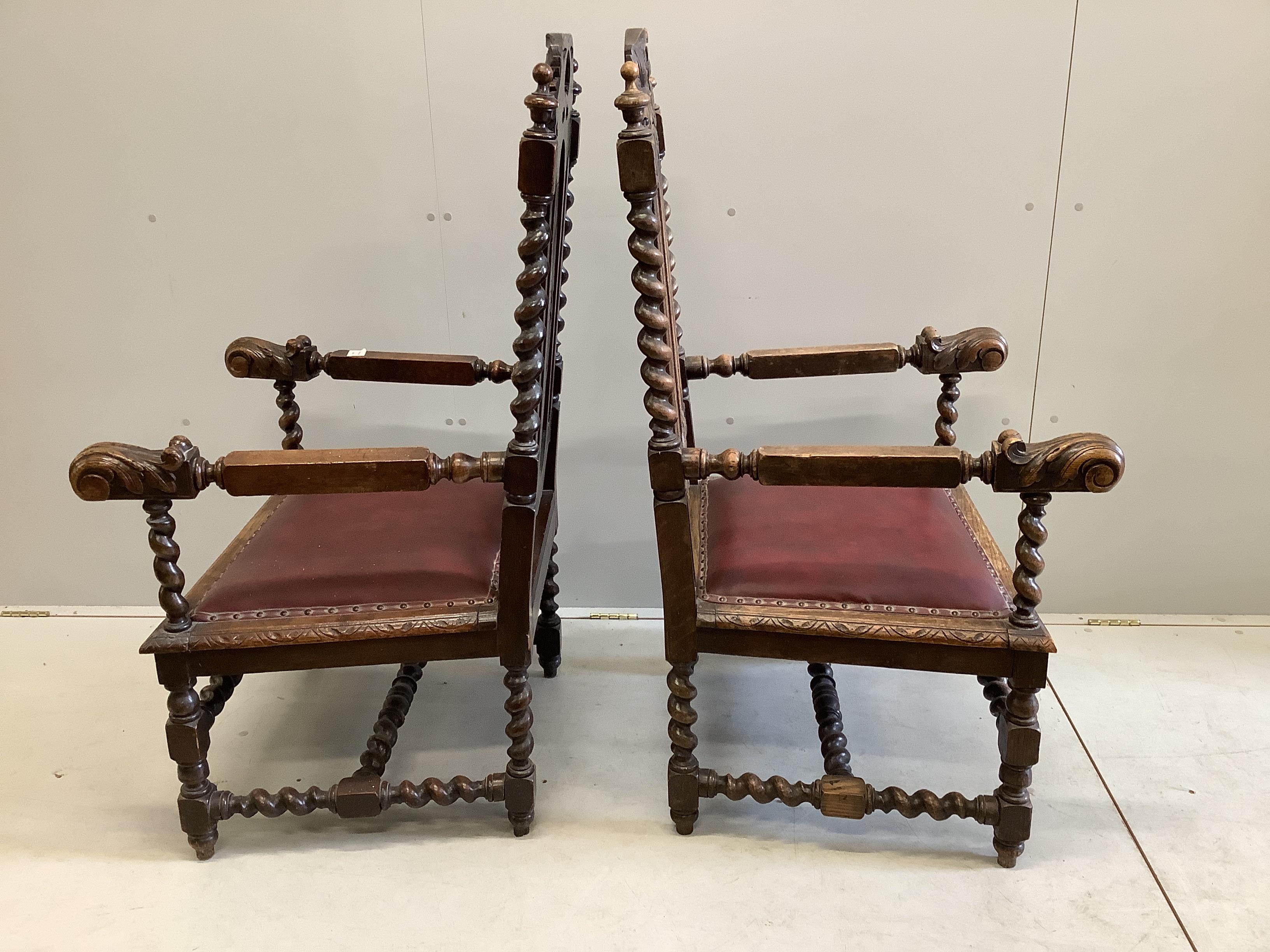 A pair of late Victorian carved oak elbow chairs, width 69cm, depth 63cm, height 122cm